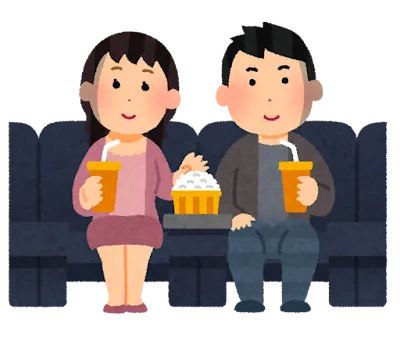 ポップコーンを食べながら、映画を観ているカップル